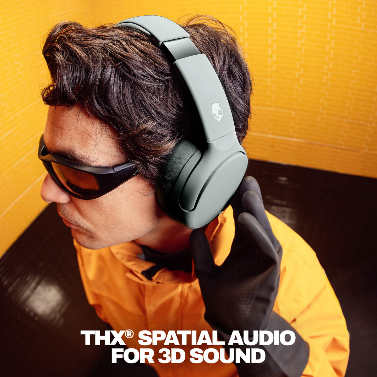 Person wearing Crusher 720 headphones with 'THX Spatial Audio For 3D Sound' text on a yellow background | Cement